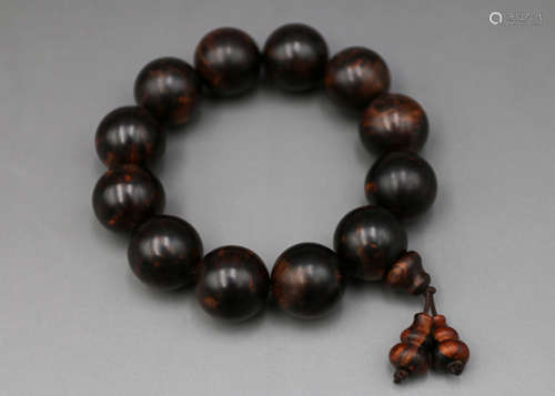 A Chinese Carved Huanghuali Bracelet