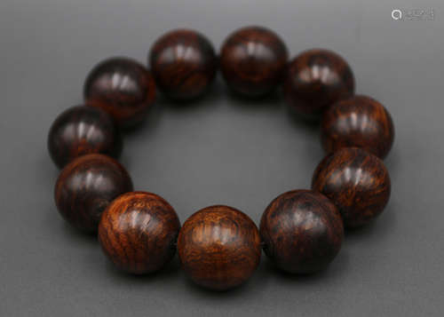 A Chinese Carved Huanghuali Bracelet