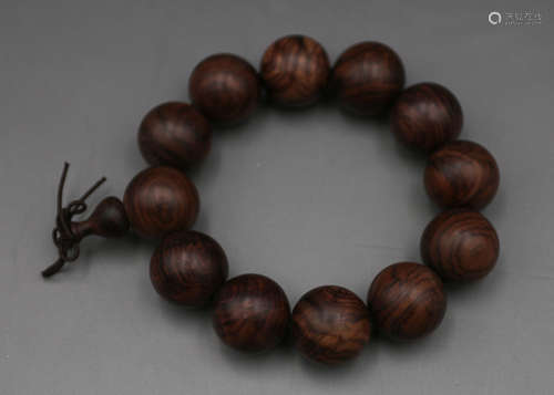 A Chinese Carved Huanghuali Bracelet