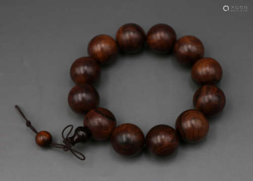 A Chinese Carved Huanghuali Bracelet