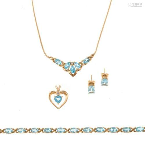 A Collection of Blue Topaz Jewelry in Gold