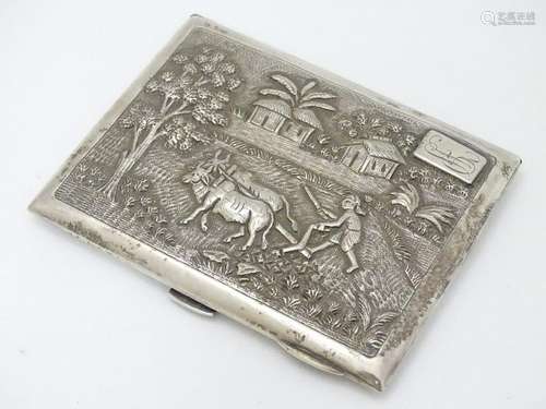 A Sterling silver cigarette case with decoration to lid