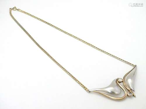 A silver and silver gilt necklace and modernist pendant