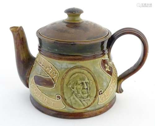 A Doulton Lambeth teapot decorated with a moulded bust