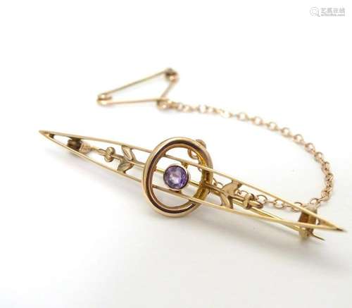 A 9ct gold bar brooch set with central amethyst 2''