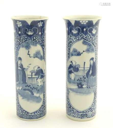 A pair of blue and white Japanese cylindrical vases