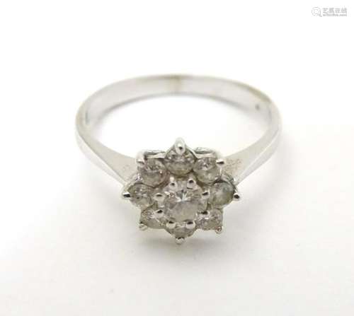 A 9ct white gold ring set with diamond cluster.