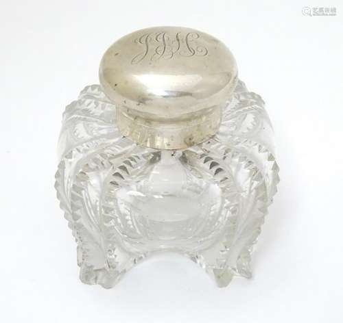 A Victorian glass inkwell with silver top hallmarked