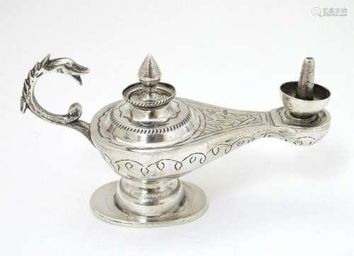 An Egyptian silver table lighter of roman lamp /