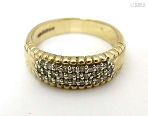 A 9ct gold ring set with pave set diamonds