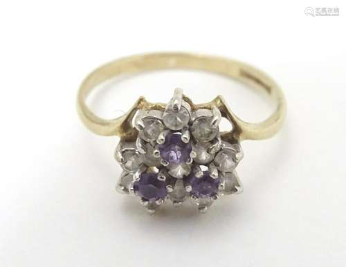 A 9ct gold ring set with amethysts and white stones