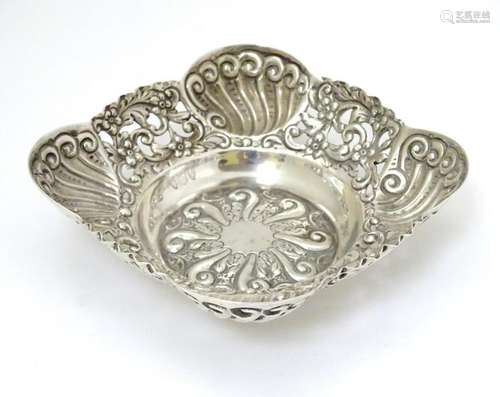 A Victorian silver bon bon dish with ornate embossed