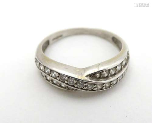 A 9ct white gold ring set with white stones in linear