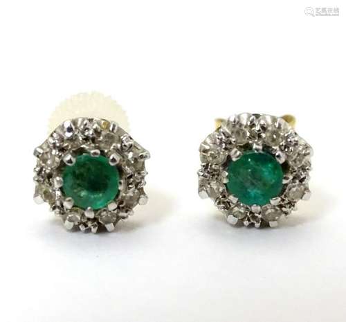 A pair of 18ct gold stud earrings set with central