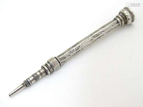 A white metal pencil with amethyst coloured stone to