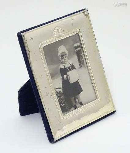 An easel back photograph frame with silver surround. 5