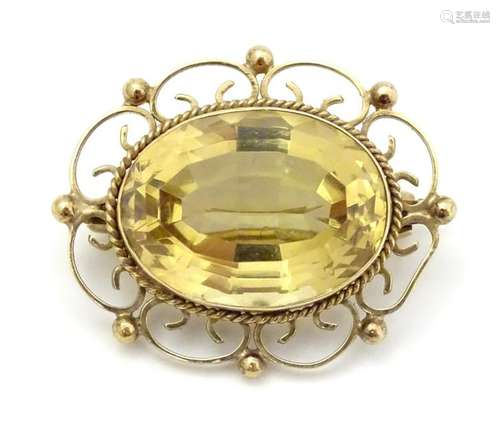 A 9ct gold brooch set with central cairngorm (citrine)