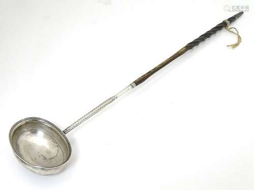 A Geo III silver toddy ladle with engraved armorial