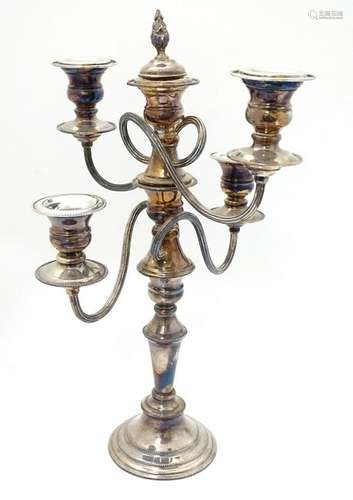 A silver plate table candelabrum having four scrolling