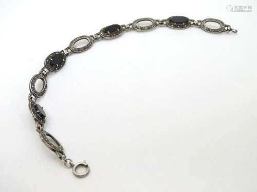 A silver bracelet set with onyx and marcasite