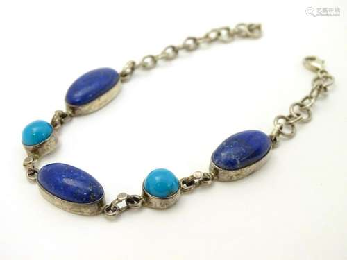 A silver bracelet set with lapiz lazuli and turquoise