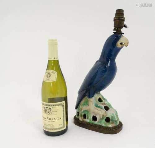 A ceramic lamp in the form of a blue parrot. 15 Â½''