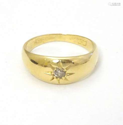 A vintage 18ct gold ring set with central diamond