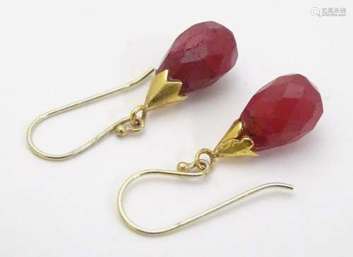 A pair of gilt metal drop earrings set with facet cut