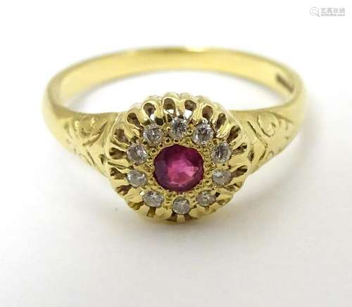 An 18ct gold ring set with central ruby bordered by