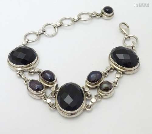 A late 20thC  silver bracelet set with facet cut onyx