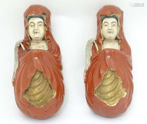 A pair of ceramic wall pockets formed as Oriental