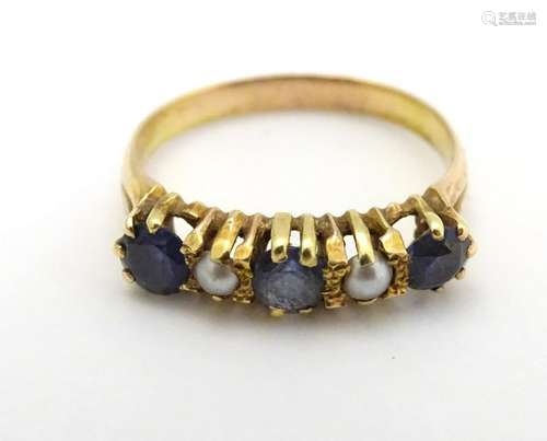 An early -  mid 20thC 18ct gold ring set with sapphires