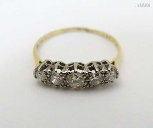 A 9ct gold ring set with 5 graduated diamonds in a