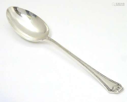 A silver teaspoon imported by Stockwell & Co  London