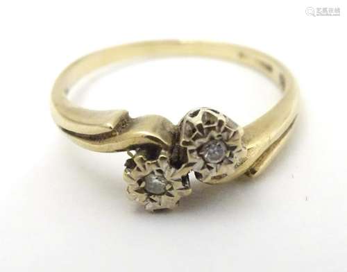 A 9ct gold ring set with 2 diamonds totalling approx