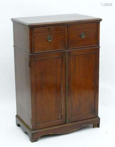 A Regency mahogany cabinet with a moulded top above two