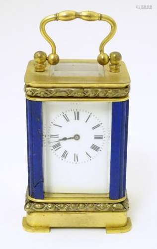 A c.1900 miniature 8 day carriage clock: a gilded brass