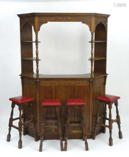 A mid 20thC oak cocktail bar with a moulded cornice