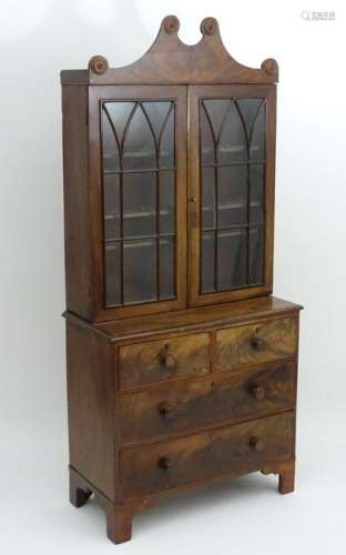 A William IV mahogany bookcase with a shaped pediment
