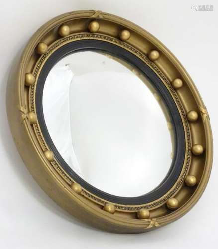 A mid 20thC Aisonea circular convex gilt mirror with