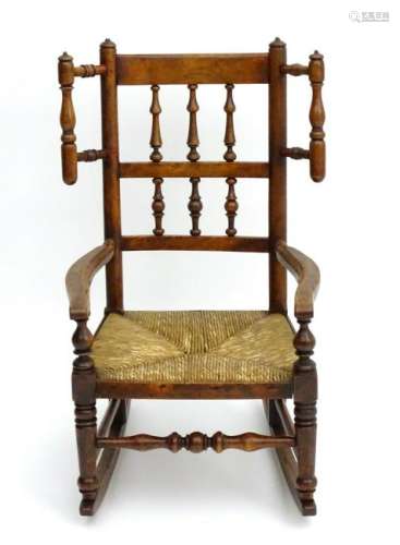 A mid 19thC Alder wood childs rocking chair with a