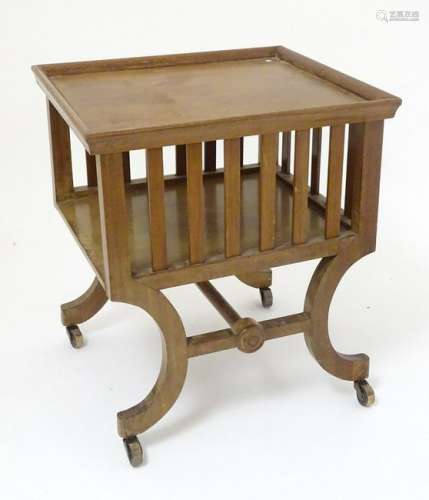 A mid 20thC mahogany magazine rack, with slatted sides