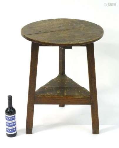 An early 19thC oak cricket table of peg jointed