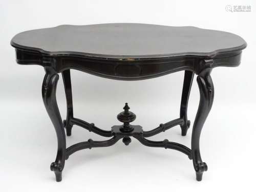 A late 19thC ebonised centre table, having a top of