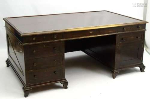 A large early 20thC double pedestal desk with four