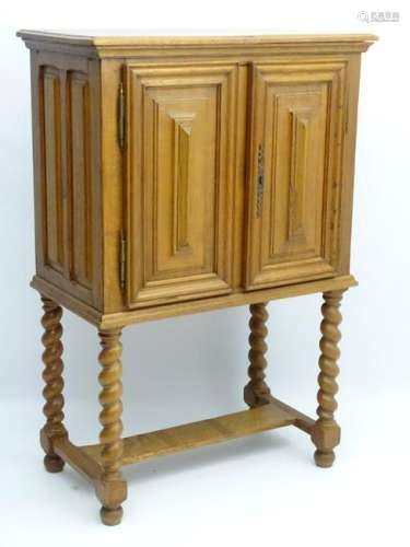 An early / mid 20thC oak cabinet with paneled sides and