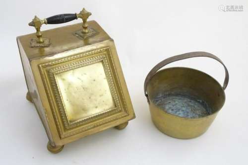 Circa 1900, a brass fireside coal scuttle with ebonised