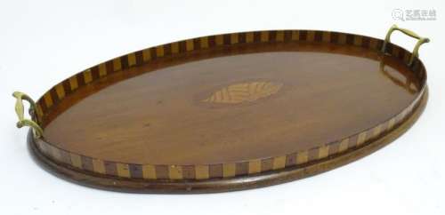 An Edwardian Sheraton Revival oval mahogany tray with