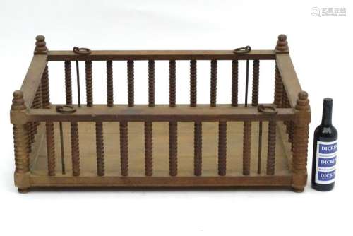 An early 20thC hanging crib with turned wooden railings
