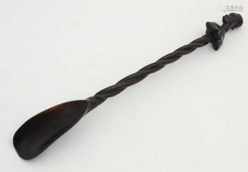 A carved ebony shoe-horn with barley twist shaft and